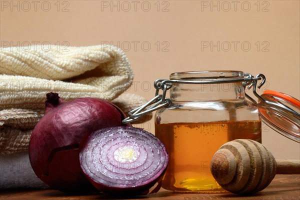 Honey in a jar and red onion, ingredients for cough syrup