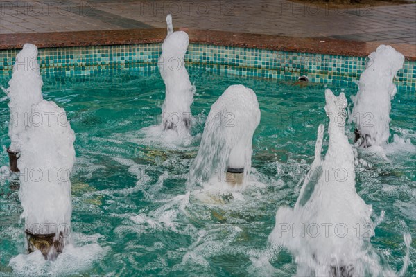 Closeup of water coming out of flow pipes in shallow fountain in Istanbul, Turkiye