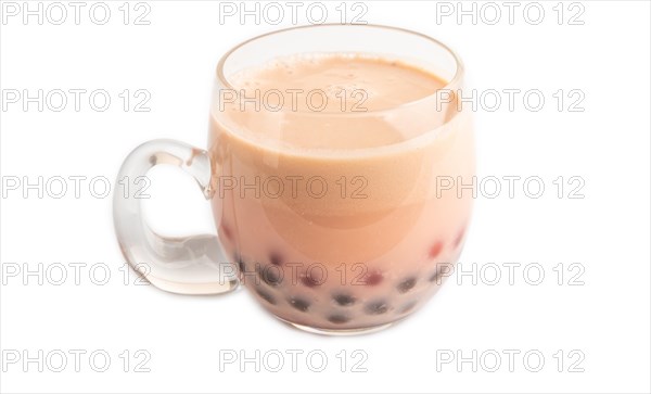 Bubble tea with pistachio and caramel in glass isolated on white background. Healthy drink concept. Side view, close up