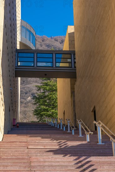 Modern Design Building with Staircase and Covered Bridge and Mountain in Campione d'Italia, Lombardy, Italy, Europe