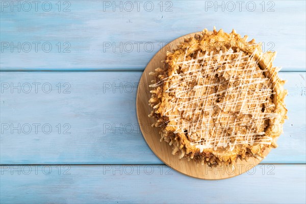 Traditional lithuanian cake shakotis on blue wooden background. top view, flat lay, copy space