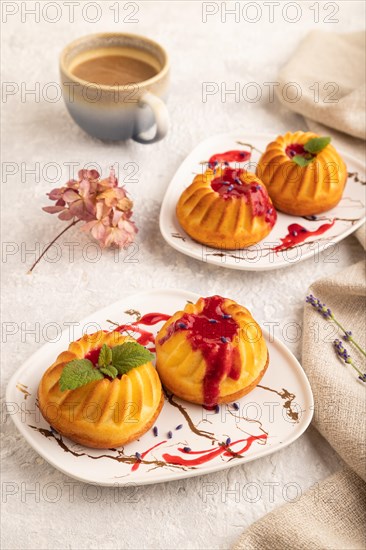 Semolina cheesecake with strawberry jam, lavender, cup of coffee on gray concrete background and linen textile. side view, close up