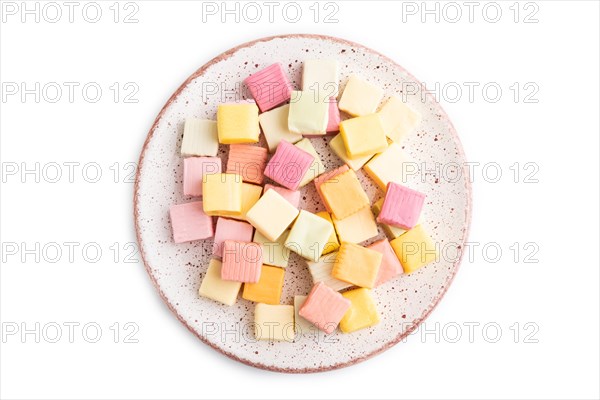 Various fruit jelly chewing candies on plate isolated on white background. apple, banana, tangerine, top view, flat lay, close up