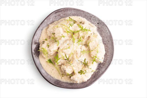 Stewed chicken fillets with coconut milk sauce and mizuna cabbage microgreen isolated on white background. top view, flat lay, close up