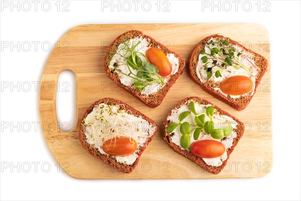 Red beet bread sandwiches with cream cheese, tomatoes and microgreen isolated on white background. top view, flat lay, close up