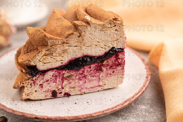 Zephyr or marshmallow cake with cup of coffee on brown concrete background and orange textile. side view, close up, selective focus