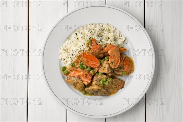 Portion of beef goulash with carrot and rice, top view