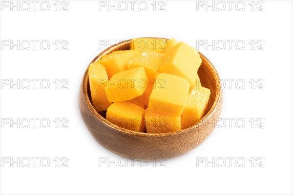 Dried and candied mango cubes in wooden bowls isolated on white background. Side view, close up, vegan, vegetarian food concept