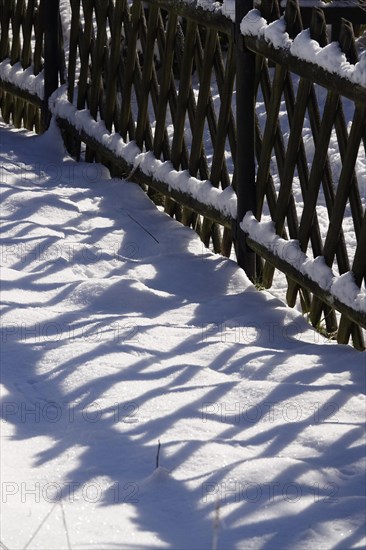 Winter in the Elbe Sandstone Mountains, fence with shade, Saxony, Germany, Europe