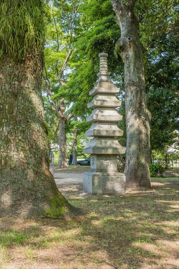 Stone carved pagoda in shady area of Peace Memorial Park in Hiroshima, Japan, Asia