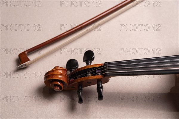 Part of a violin with bow in front of a white background, studio shot, Germany, Europe