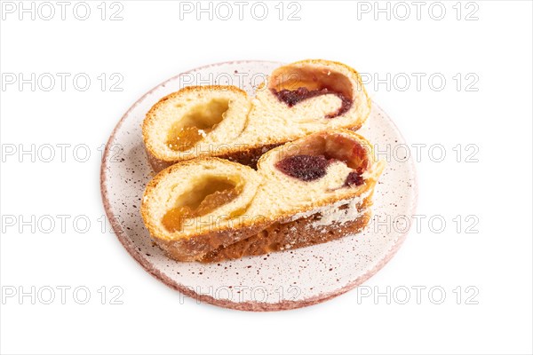 Homemade sweet bun with apricot jam isolated on white background. side view, close up