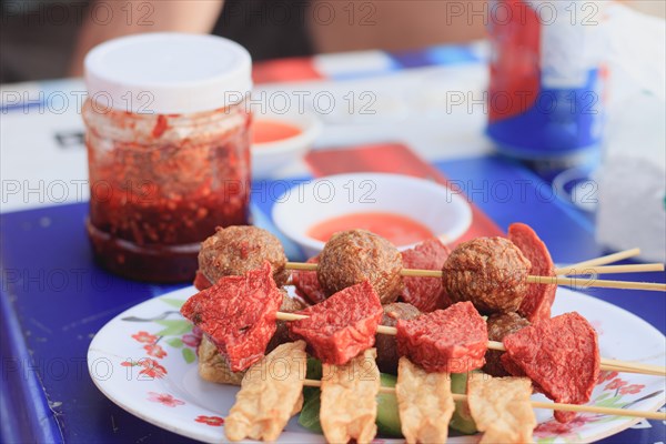 Barbecue meat skewers with sauce, typical street food