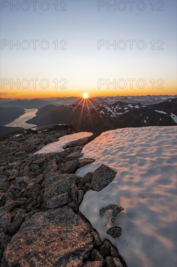 View of mountains and fjord Faleidfjorden, sun star at sunset, summit of Skala, Loen, Norway, Europe