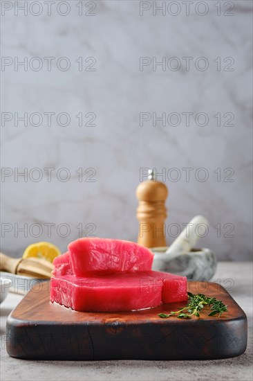 Low angle view of raw ahi tuna steak on cutting board with spice