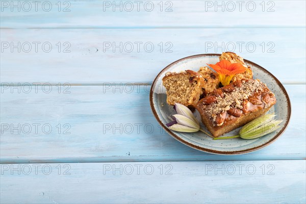 Caramel and almond cake on blue wooden background. side view, copy space
