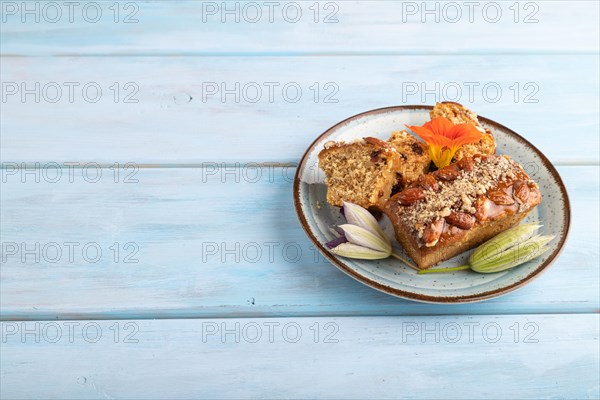 Caramel and almond cake on blue wooden background. side view, copy space