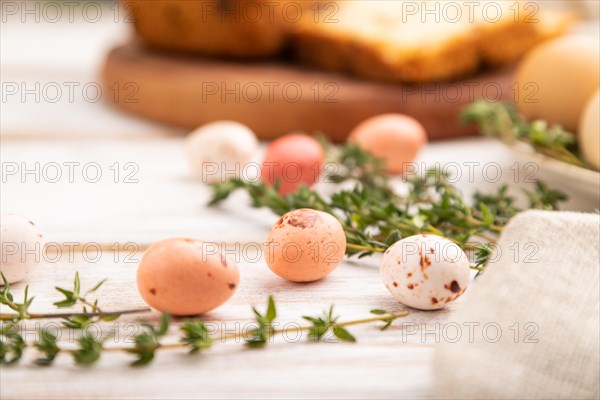 Homemade easter pie with raisins and eggs on plate on a white wooden background and linen textile. side view, close up, selective focus