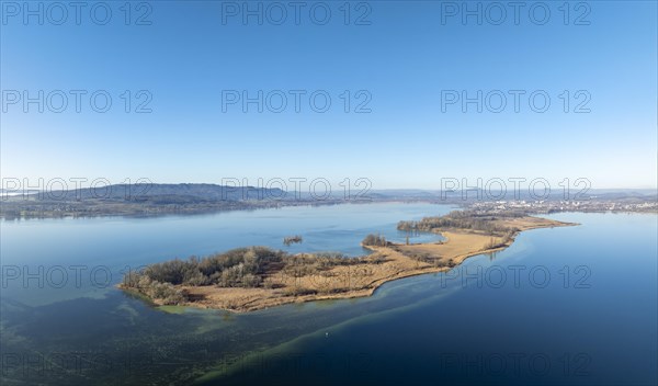 Aerial panorama of the Mettnau peninsula on a clear winter's day, with the town of Radolfzell on Lake Constance and the Hegau mountains on the horizon to the right, Constance district, Baden-Wuerttemberg, Germany, Europe