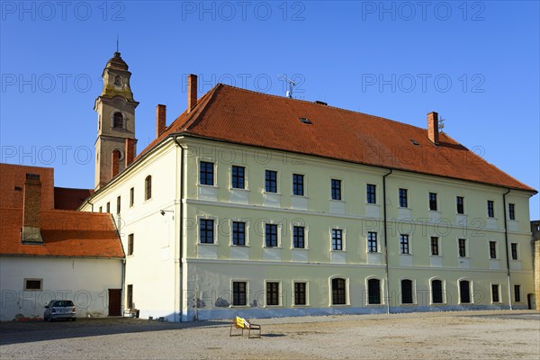 Historic building under a blue sky with a prominent tower in the midst of peaceful surroundings, Franciscan Church of the Seven Sorrows and Franciscan Monastery, Skalica, Skalica, Trnavsky kraj, Slovakia, Europe