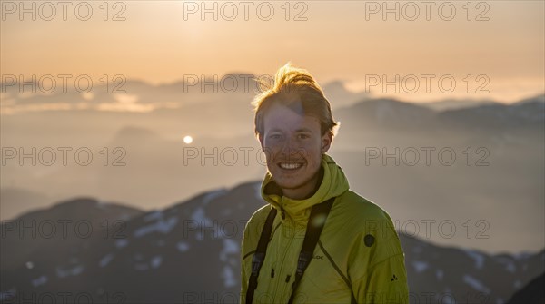 Mountaineer on the summit of Skala with cairn, view of mountain landscape and fjord Faleidfjorden, Sonnenstern, Loen, Norway, Europe