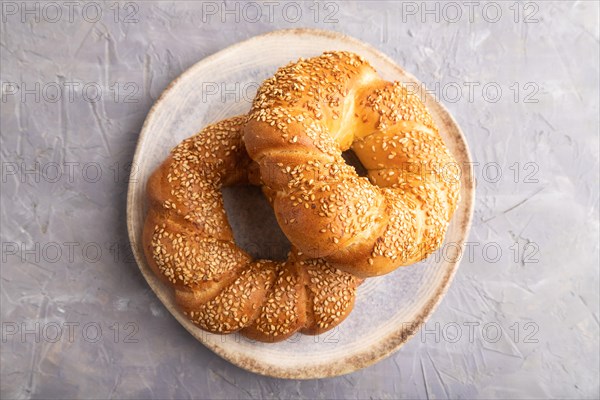 Homemade sweet bun on a gray concrete background. top view, flat lay, close up