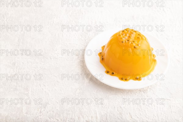Mango and passion fruit jelly on gray concrete background. side view, copy space