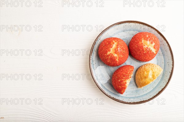 Traditional french custard dessert shu cake on white wooden background. top view, flat lay, copy space. Breakfast, morning, concept