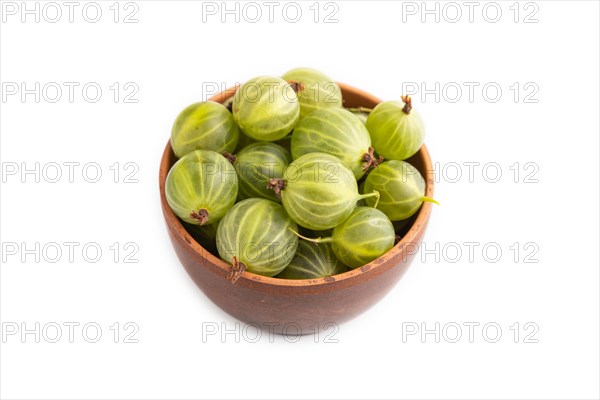 Fresh green gooseberry in clay bowl isolated on white background. side view, close up