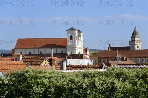Town view with church and historical buildings under clear blue sky, view of Roman Catholic Church of St Francis Xavier and Roman Catholic Parish Church of St Michael, Skalica, Skalica, Trnavsky kraj, Slovakia, Europe