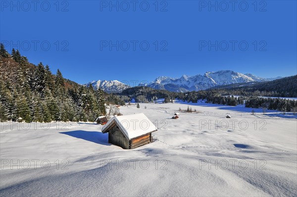 View of the frozen and snow-covered Geroldsee lake in Werdenfelser Land near Garmisch, with the Karwendel mountains in the background, Bavaria, Germany, Europe