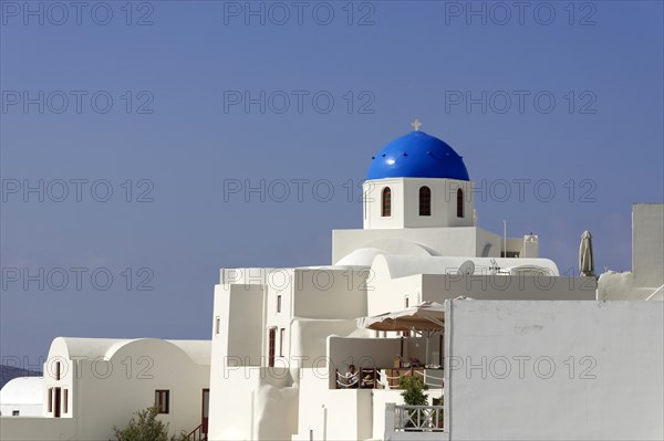 White houses in typical Cycladic architecture, above a Greek domed church, Oia, Ia, Santorini, Cyclades, Greece, Europe
