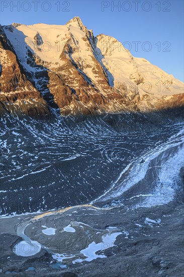 Glacier tongue and snow-covered mountain peak at sunrise, Grossglockner and Pasterze, autumn, Hohe Tauern National Park, Carinthia, Austria, Europe