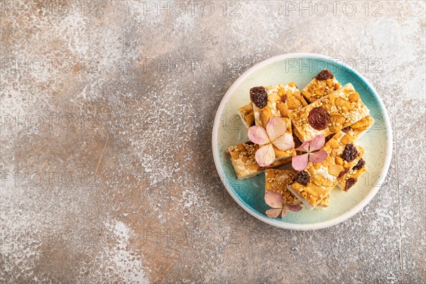 Traditional candy nougat with nuts and sesame on brown concrete background. top view, flat lay, copy space