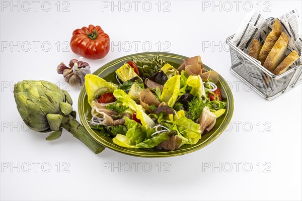 Food photography Various salads with artichokes and Serrano ham