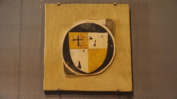 Ancient medieval coat of arms on a shield with a cross and in yellow, black and white colours, Chlemoutsi, high medieval crusader castle, Kyllini peninsula, Peloponnese, Greece, Europe