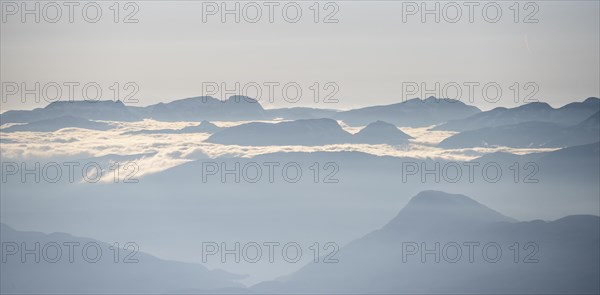 High fog between mountain peaks, view from the summit of Skala, Loen, Norway, Europe