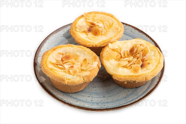 Traditional portuguese cakes pasteis de nata, custard small pies with almonds isolated on white background. Side view, close up