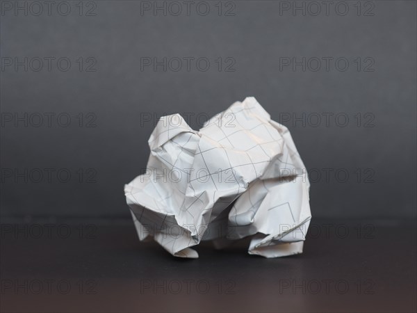 White paper ball over dark gray background