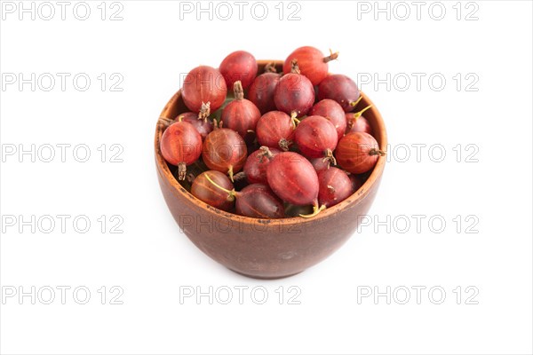 Fresh red gooseberry in clay bowl isolated on white background. side view, close up