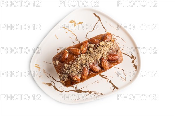 Caramel and almond cake isolated on white background. top view, flat lay, close up