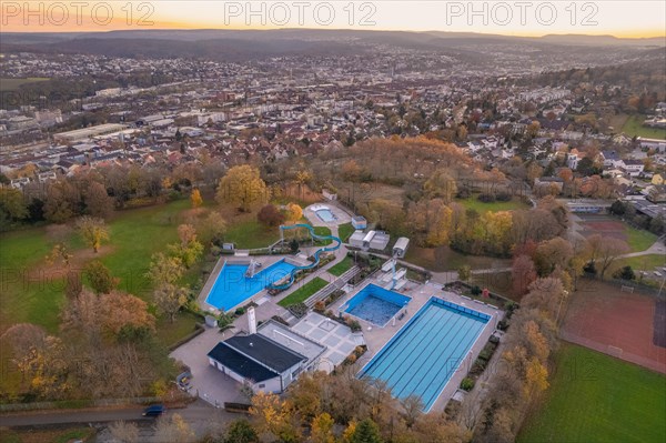 Aerial view of a swimming pool surrounded by trees in autumn colours, Pforzheim, Germany, Europe