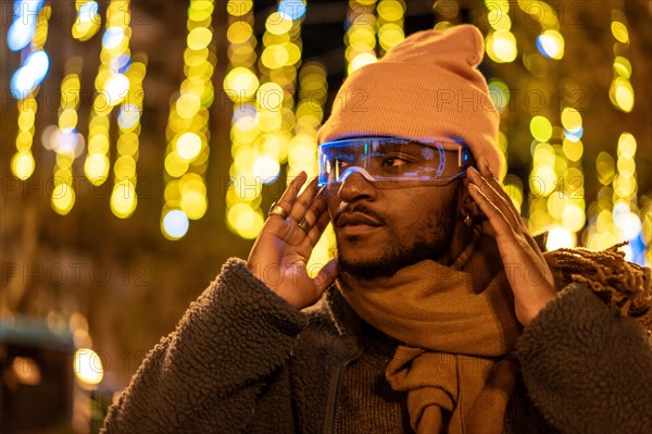 African man using smart glasses in a futuristic city with illuminated streets at night