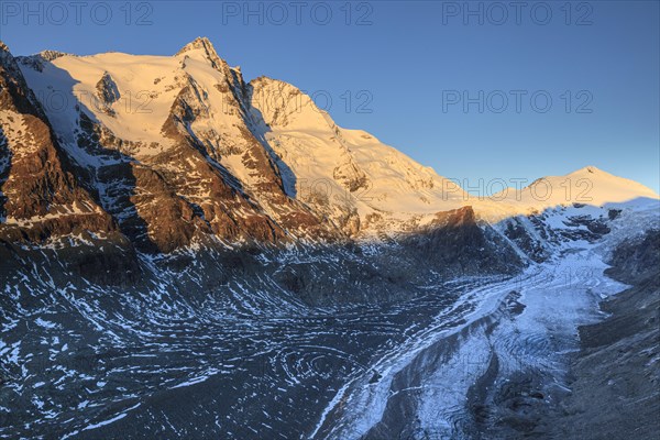 Glacier tongue and snow-covered mountain peak at sunrise, Grossglockner and Pasterze, autumn, Hohe Tauern National Park, Carinthia, Austria, Europe