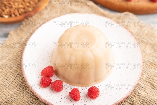 Buckwheat milk jelly on gray wooden background and linen textile. side view, close up, selective focus