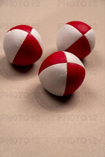 Three juggling balls in front of a light background, selective focus, studio shot, Germany, Europe