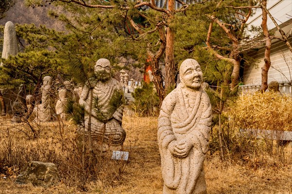 Stone carved Buddhist deities in garden at temple in South Korea