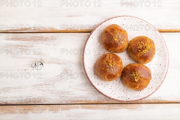 Homemade traditional turkish dessert sekerpare with almonds and honey on white wooden background. top view, flat lay, copy space