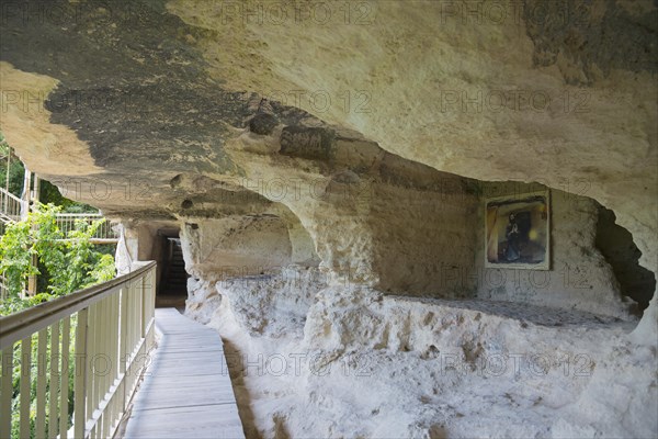 Path with railing leads to a cave dwelling surrounded by vegetation, Aladja Monastery, Aladja Monastery, Aladzha Monastery, medieval rock monastery, cave monastery in limestone cliff, Varna, Black Sea coast, Bulgaria, Europe