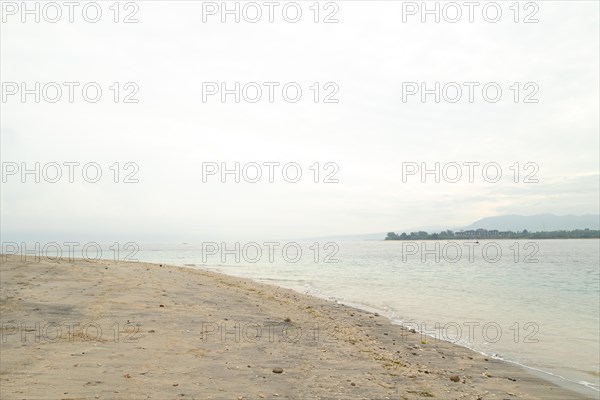 Lombok and Gili Air islands, overcast, cloudy day, sky and sea. Vacation, travel, tropics concept, no people. Sunny day, sand beach